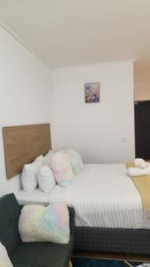 a small room with a bed and a couch at El Roi on NINE PALMS in Cape Town