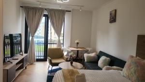 a living room with a couch and a chair and a tv at El Roi on NINE PALMS in Cape Town