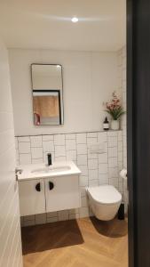 a white bathroom with a sink and a toilet at El Roi on NINE PALMS in Cape Town +13 photos