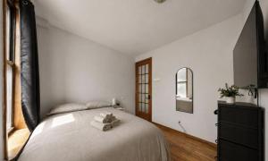 a bedroom with a bed with a dresser and a mirror at The NYC Value Room near Times Square & Broadway - Private Room with shared bathroom in New York