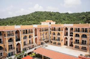 an overhead view of a building with a mountain in the background at Oshana Stays,Fully furnished Studio Apartment with Pool,Sauna,Siolim, Goa in Mapusa