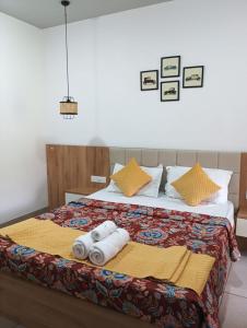a bedroom with a bed with towels on it at Oshana Stays,Fully furnished Studio Apartment with Pool,Sauna,Siolim, Goa in Mapusa +69 photos