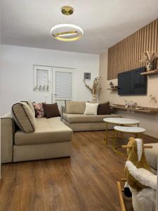 a living room with two couches and a table at Topuzi Grand House in Pogradec