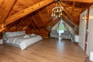 a bedroom with a bed and two chairs at KayakHotel in Ndërlisaj +7 photos