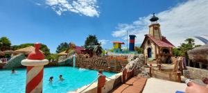 a pool at a water park with people in it at Oasis Blue Resort - Hotel & Residenz Apartments Strandnähe in Caorle
