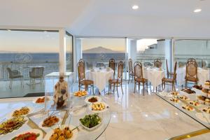 a dining room with a table with plates of food at Boutique Hotel Regina in Sorrento
