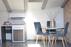a dining room with a table and chairs at San Mauro rooms in Poreč