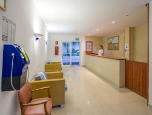 a hospital lobby with a woman standing at the counter at Apartamentos Sol Bay in San Antonio Bay