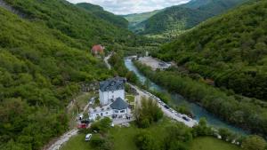 an aerial view of a house next to a river at KayakHotel in Ndërlisaj