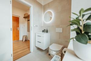 a bathroom with a toilet and a sink at CityBeat Apartments, 400m from the square in Pilsen +123 photos