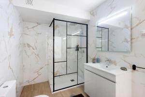 a white bathroom with a shower and a sink at Manuel'shouse in Vila Nova de Gaia +16 photos