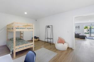 a bedroom with a bunk bed and a living room at Manuel'shouse in Vila Nova de Gaia