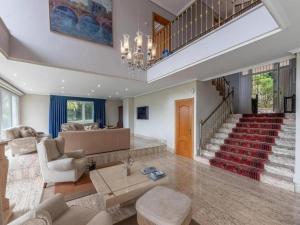 a living room with a couch and a table at VILLA ISLAS Urdaibai in Isla Becoa
