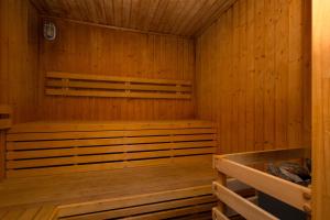 a sauna with wooden walls and a wooden floor at Hotel Velky Meder in Veľký Meder