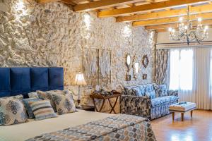 a bedroom with a bed and a couch at Avli Lounge Apartments in Rethymno +129 photos