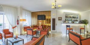 a lobby with chairs and a bar in a hotel at Boutique Hotel Regina in Sorrento
