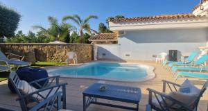 a patio with chairs and a swimming pool at Casa Sinzias con piscina 9 posti letto in Castiadas