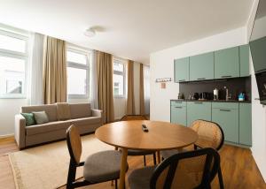 a living room with a table and a kitchen at Limehome Gelsenkirchen Hochstr in Gelsenkirchen