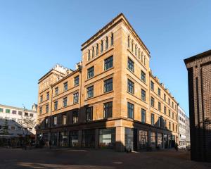 a large brick building on a city street at Limehome Gelsenkirchen Hochstr in Gelsenkirchen
