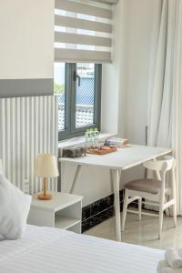 a white bedroom with a table and a bed at Casa De Sol Resort - Wuwei Retreat in Phú Quốc