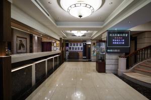 a lobby of a building with a sign on the wall at K Hotel Keelung in Keelung