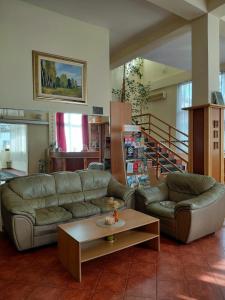 a living room with a couch and a coffee table at Hotel Slodes in Belgrade