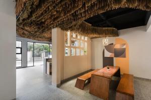 a room with a bench and a table at Cove Vaia in Bandung