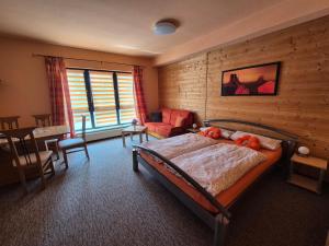 a bedroom with a bed and a chair and a table at Apartments Schramm in Eisenach