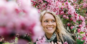 a woman standing in front of pink flowers at Lapland Hotels Arena in Tampere +55 photos