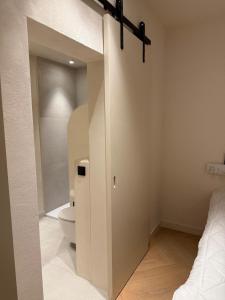 a bathroom with a toilet and a bed in a room at Duin & Zee in Ostend