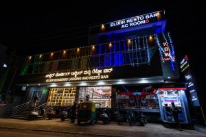 a store with motorcycles parked in front of it at night at Elixir Boarding & Lodging in Bangalore