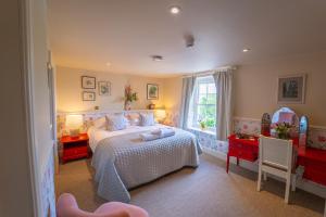 a bedroom with a large bed and a window at The Market Tavern in Bampton