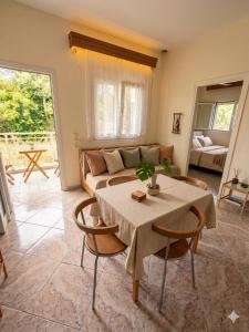 a living room with a table and a couch at Don Bazilio Brace in Leptokarya +22 photos