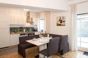 a kitchen and dining room with a table and chairs at BergZeit Apartments in Spital am Semmering