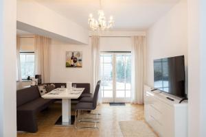 a living room with a couch and a table and a tv at BergZeit Apartments in Spital am Semmering