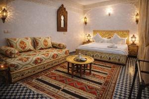 a living room with a bed and a couch at Hotel Larayhana in Fez
