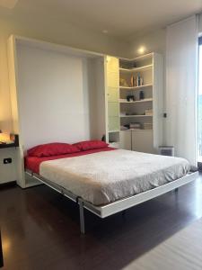 a bedroom with a large bed with red sheets at Nice Gecko in Baveno