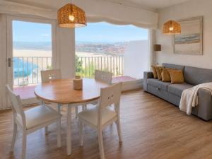 a living room with a table and a couch at Casa Roca Blanca Suances in Suances