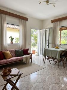 a living room with a couch and a table at Don Bazilio Brace in Leptokarya