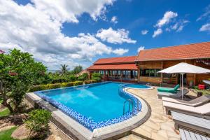 an image of a swimming pool in front of a house at Casa De Sol Resort - Wuwei Retreat in Phú Quốc