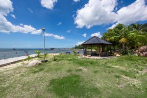 a gazebo on the beach near the water at Casa De Sol Resort - Wuwei Retreat in Phú Quốc