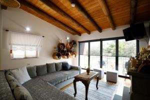 a living room with a couch and a table at Villa Shuaipaj in Gjirokastër