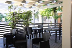 a row of tables and chairs on a patio at Hotel Giardinetto Al Sant'Orsola in Bologna