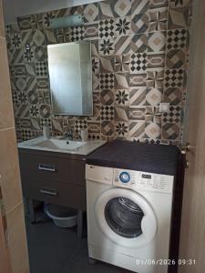 a bathroom with a washing machine and a sink at Skiathos island house in Skiathos +71 photos