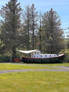 a boat sitting on the grass in a field at The Ship Aground Woolacombe in Woolacombe