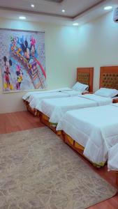 a group of four beds in a room at منتجع خيال رفيف in Ḩarshaf