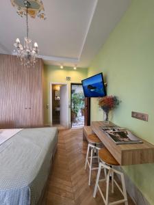 a bedroom with a bed and a desk with a tv at Rozmari Suites in Agia Galini