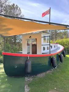 a small boat with a canopy on the grass at The Ship Aground Woolacombe in Woolacombe +18 photos