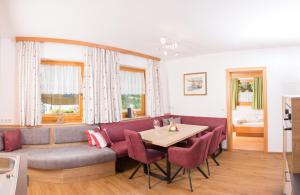 a living room with a couch and a table at Lochgrubgut in Altenmarkt im Pongau