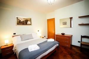 a bedroom with a bed with two towels on it at Guest House Sassuolo 2 in Sassuolo